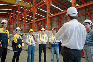 Manager holds a training meeting with warehouse workers.