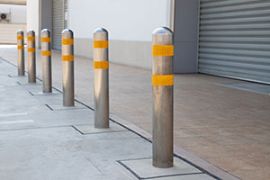 Six bollards installed to protect warehouse doors.