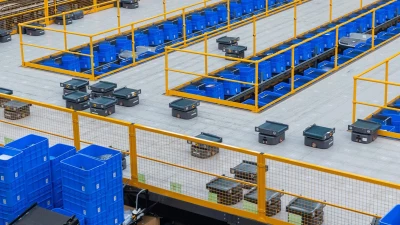 addverb-sorting-robots.png Multiple sorting robots work in a warehouse full of bins