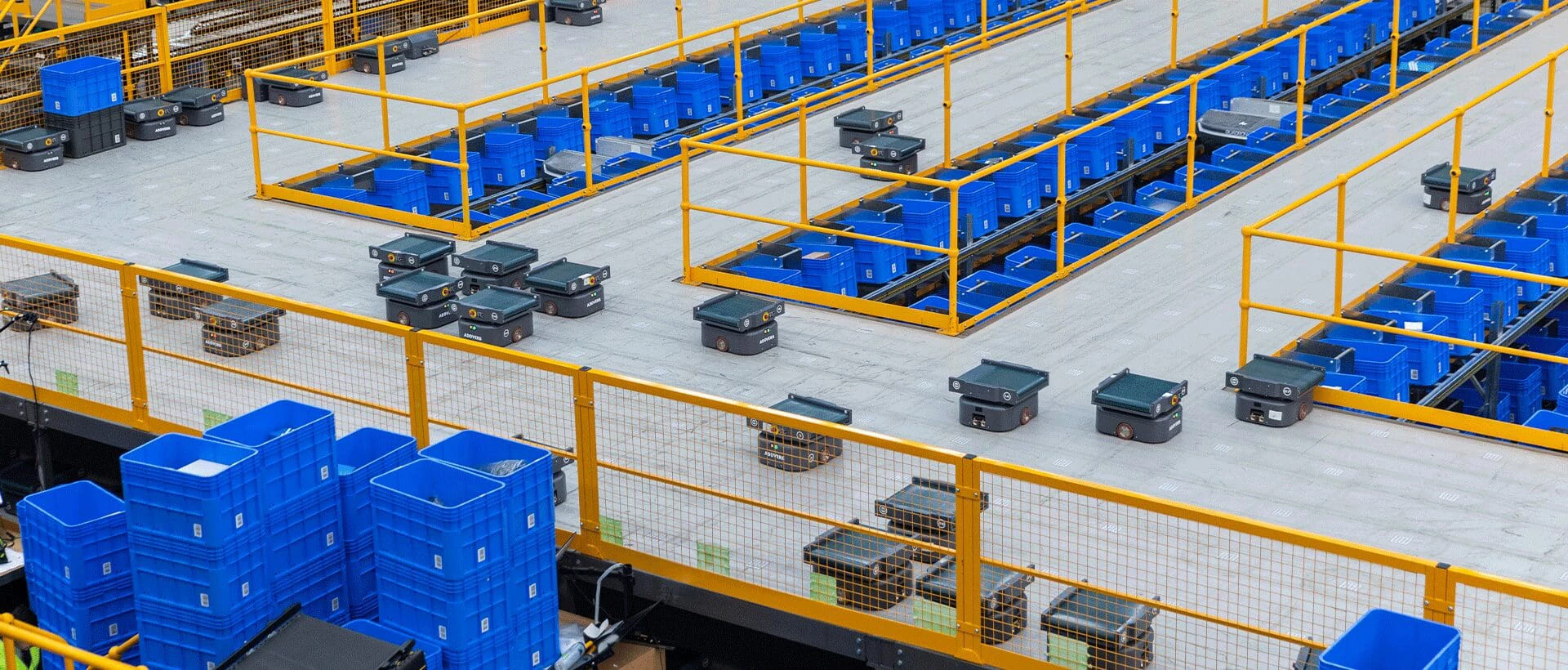 addverb-sorting-robots.png Multiple sorting robots work in a warehouse full of bins