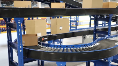automated-conveyor-systems-trew.png Close-up of an automated conveyor line transporting boxes in a warehouse