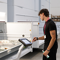 Employee picks parts from a VLM